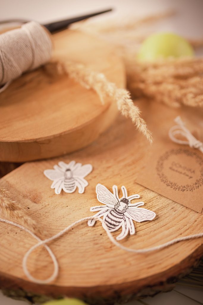 Threads and applique work ornaments on wooden board